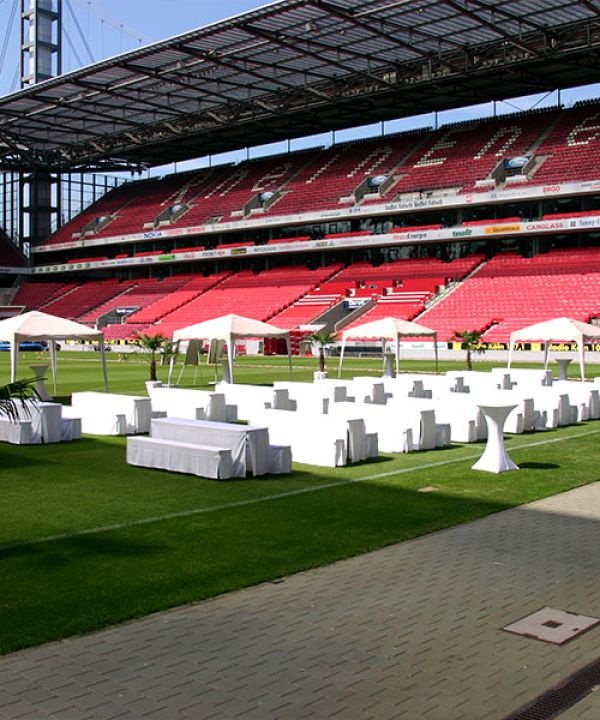 The pitch area at RheinEnergieSTADION with festively arranged tables and benches
